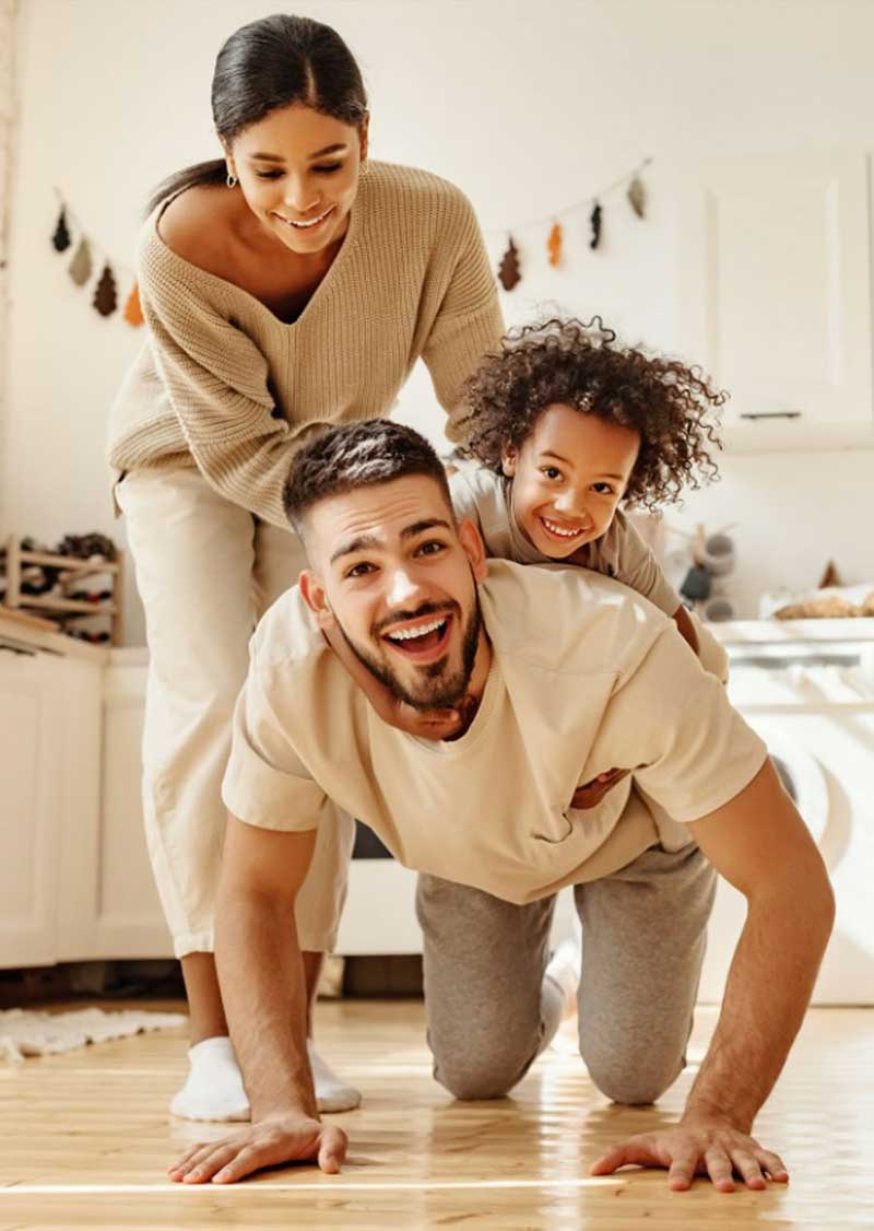 Young family of 3 playing on the floor